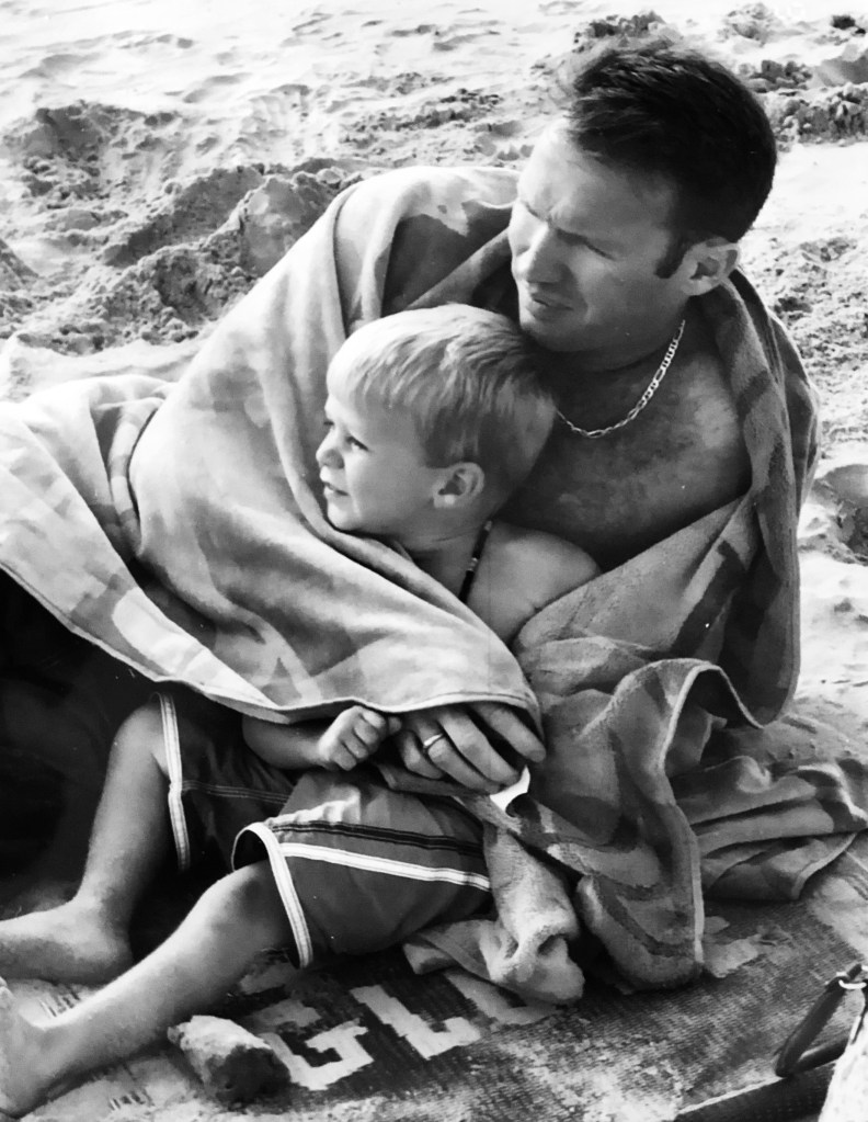 Dad and Cooper on beach.